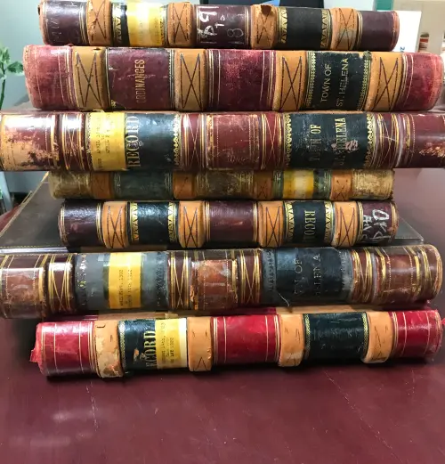 Bound historical ledgers prepared for archival book digitization